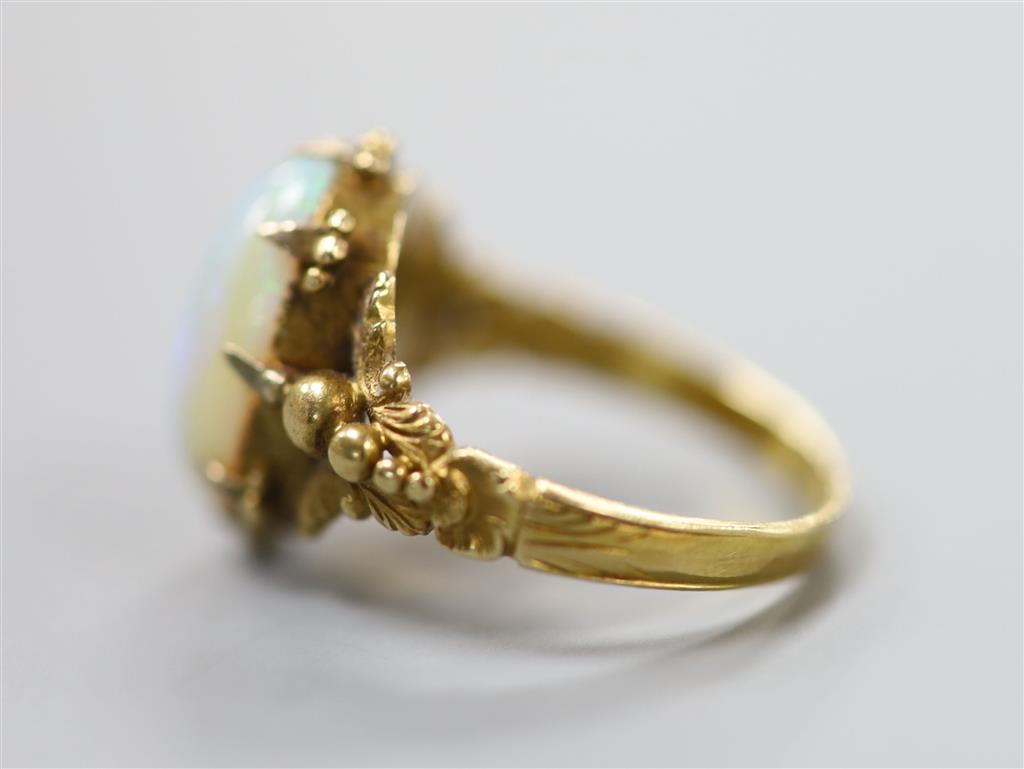 A 19th century yellow metal and oval white opal set dress ring, size M, gross 4.1 grams.